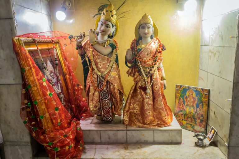 a statue of two women dressed in indian garb